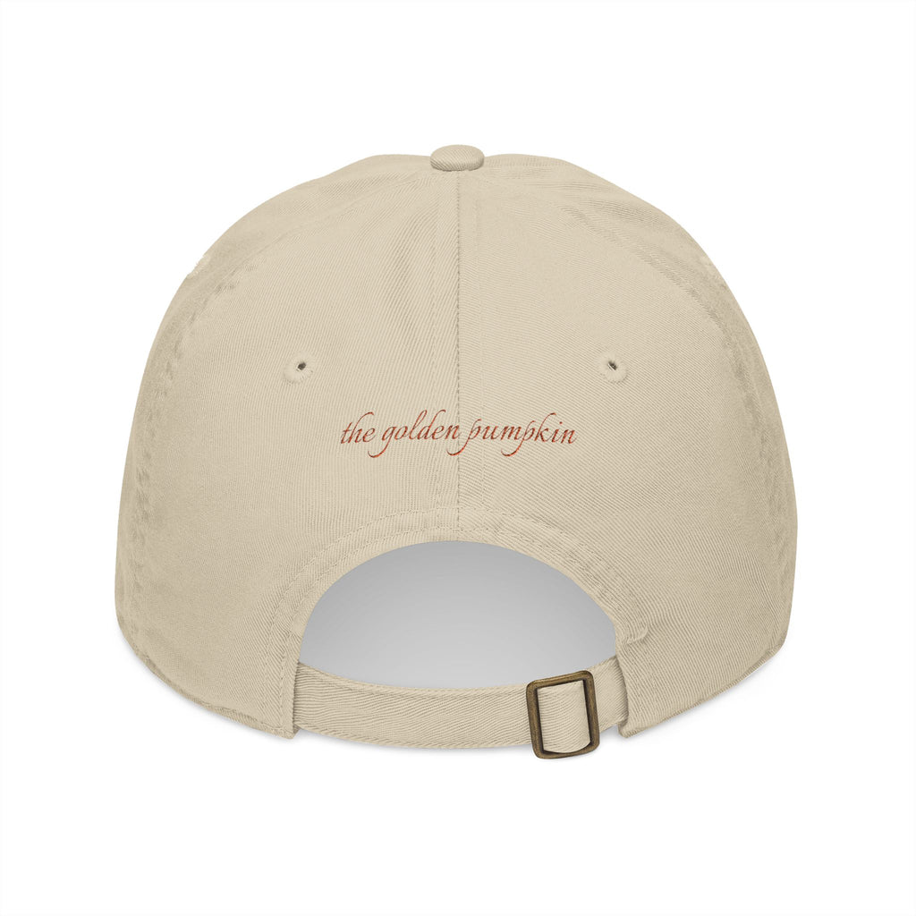 Beige baseball cap with text 'the golden pumpkin' on the back, in rusty orange color. The golden pumpkin is the store name.